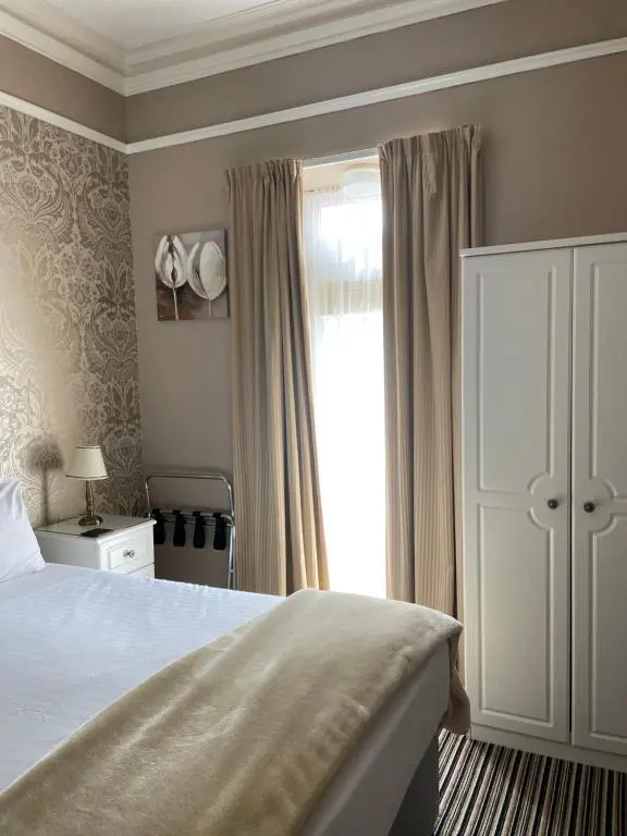 a bedroom with a large bed and a window at Inchrye Bed & Breakfast in Inverness