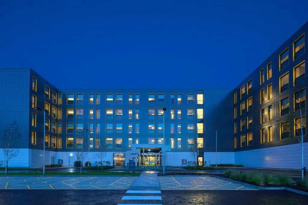 an empty parking lot in front of a building at Aloft Aberdeen TECA in Aberdeen