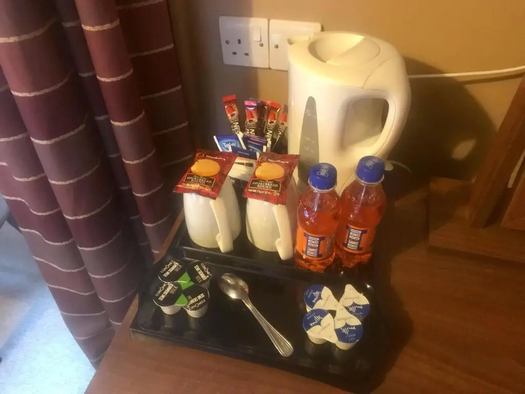 a small refrigerator with drinks and a pitcher of milk at Chieftain Hotel in Inverness