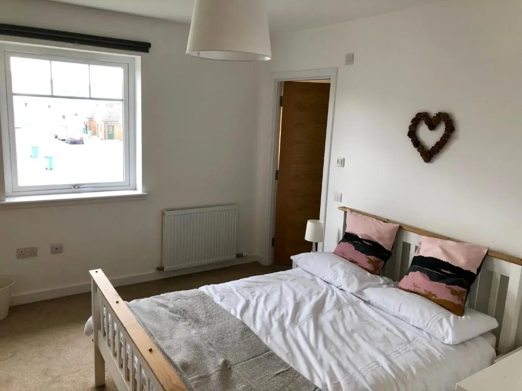 a bedroom with a bed and a window at Stelvio in Aviemore