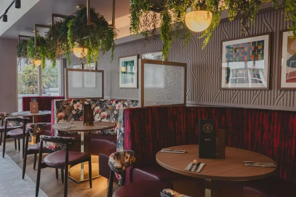 a restaurant with tables and chairs in a room at The Seafield Arms-Cullen in Cullen