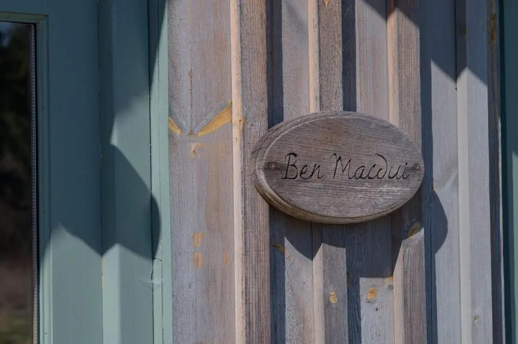a wooden door with a sign that reads bee moval at Ben Macdui in Banchory