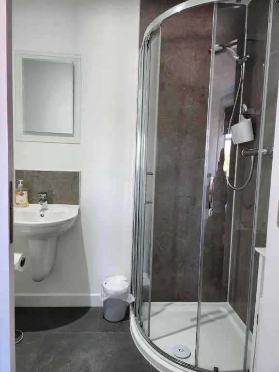 a bathroom with a shower and a sink at The Station Hotel Insch in Insch