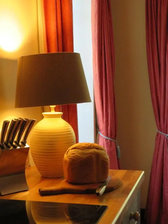 a lamp on a table with a loaf of bread on it at Balvraid Lodge B&B in Inverness