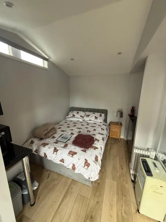 a bedroom with a bed in a room at ensuite garden room in Inverness