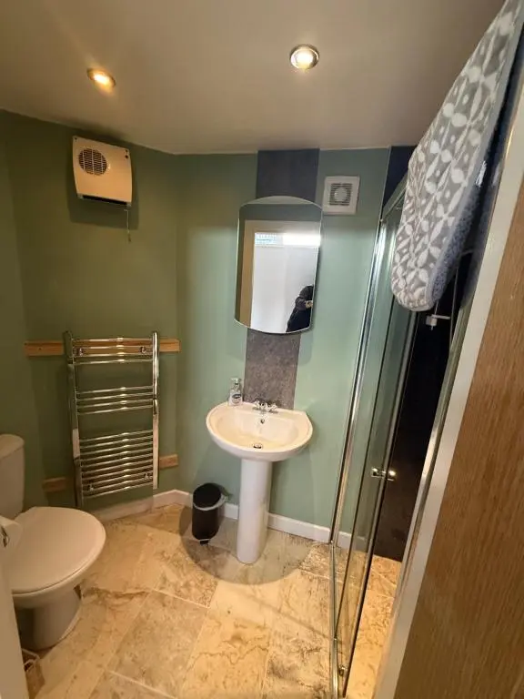 a bathroom with a sink and a shower at ensuite garden room in Inverness