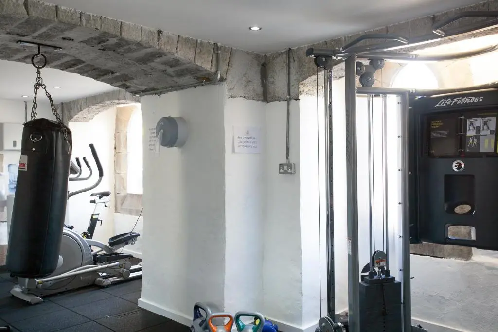 a room with a gym with a punching bag on the wall at Old School 10 Apartment With A View in Fort Augustus