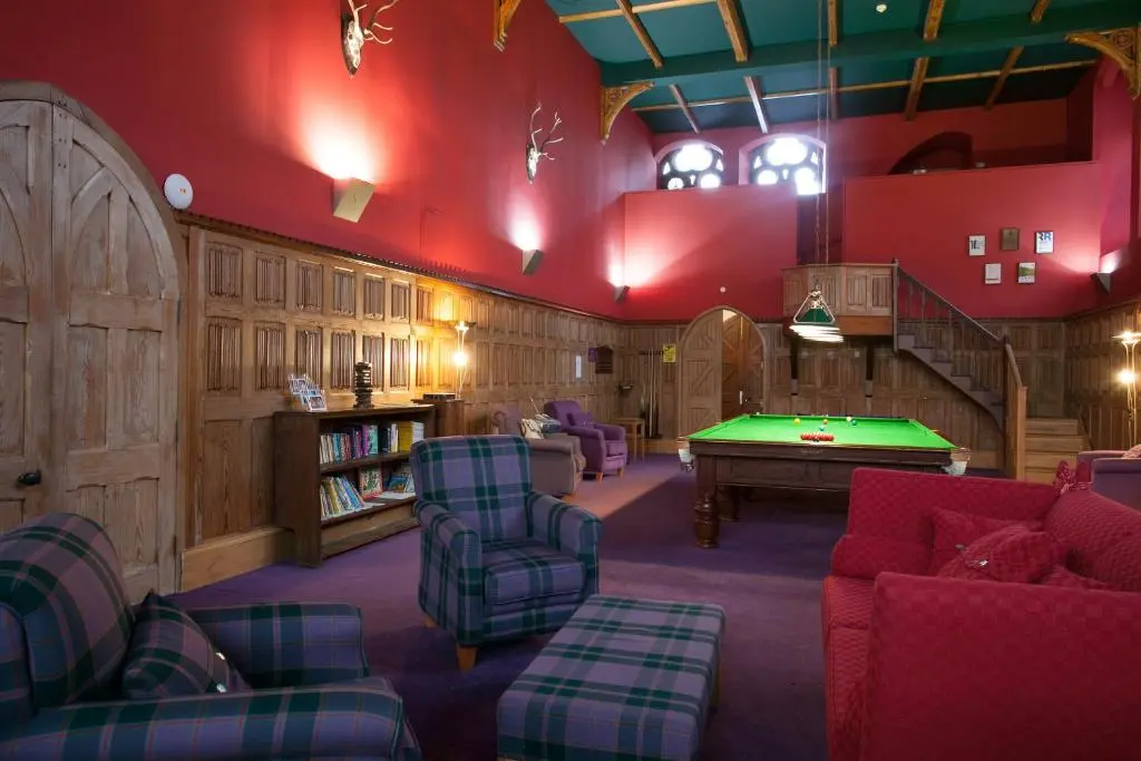 a living room with a pool table in it at Old School 10 Apartment With A View in Fort Augustus