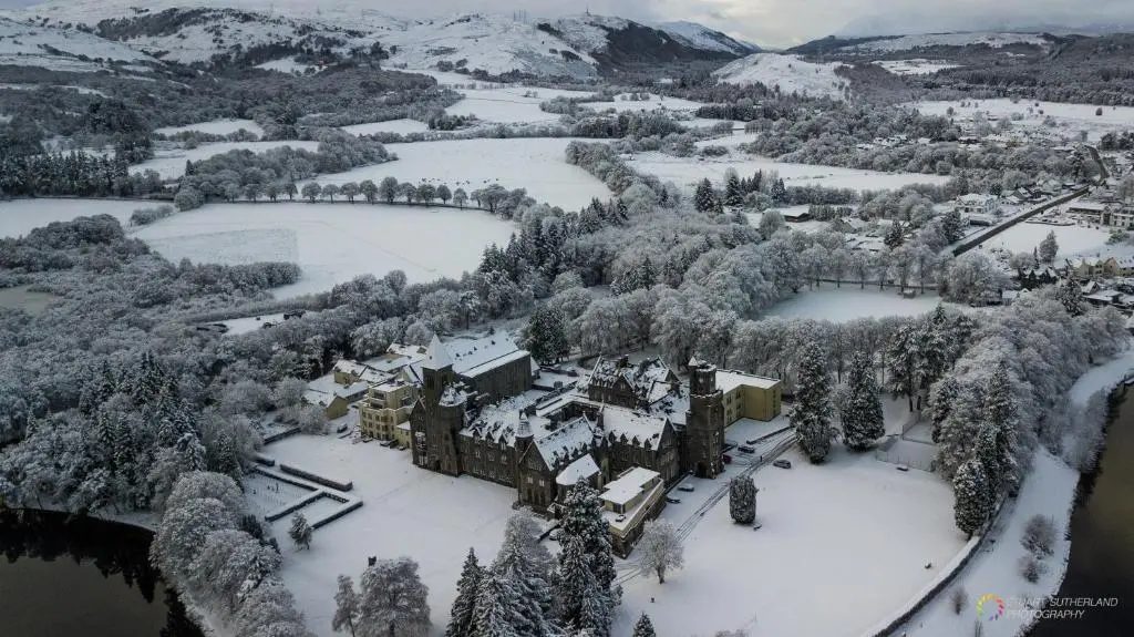 an aerial view of a castle in the snow at Old School 10 Apartment With A View in Fort Augustus