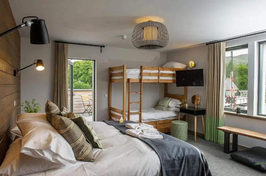 a bedroom with a bed and bunk beds in it at Lock Chambers, Caledonian Canal Centre in Fort Augustus