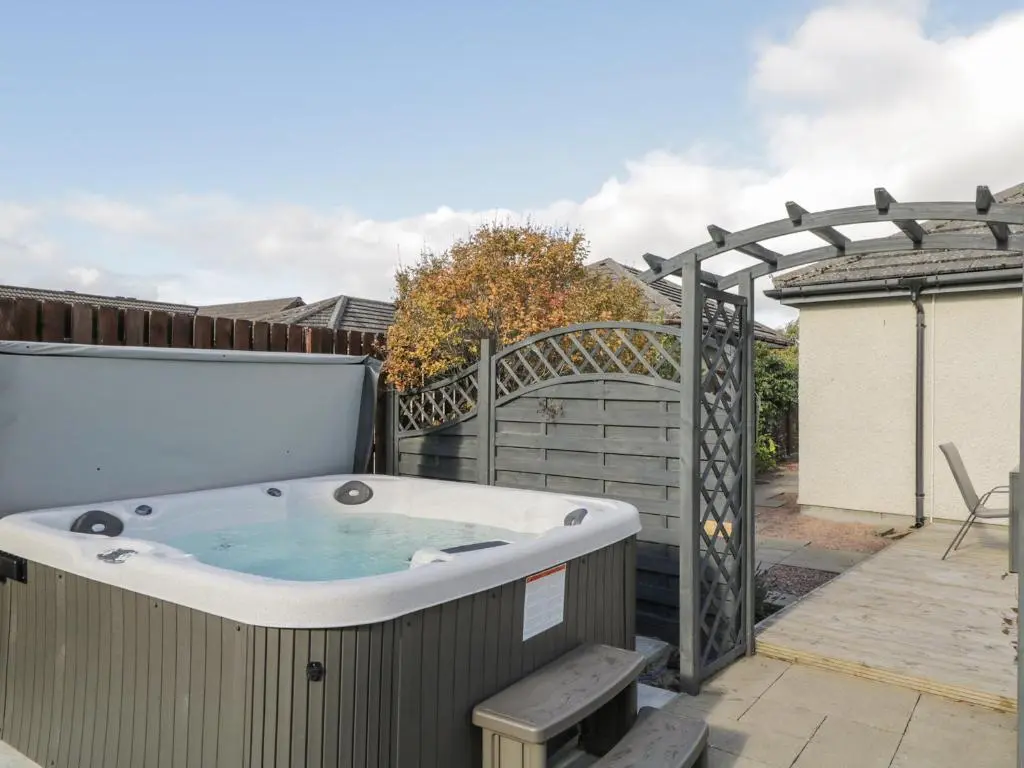 a hot tub on the back of a patio at Number 11 in Beauly