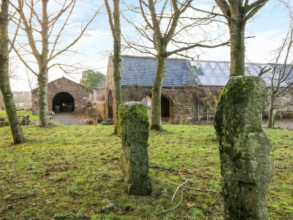an old stone church in the woods with trees at The Orangery in Turriff