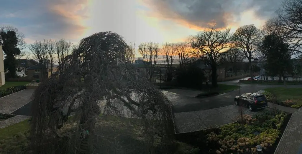 a car parked in a parking lot with a statue at Royal Golf Apartments in Dornoch