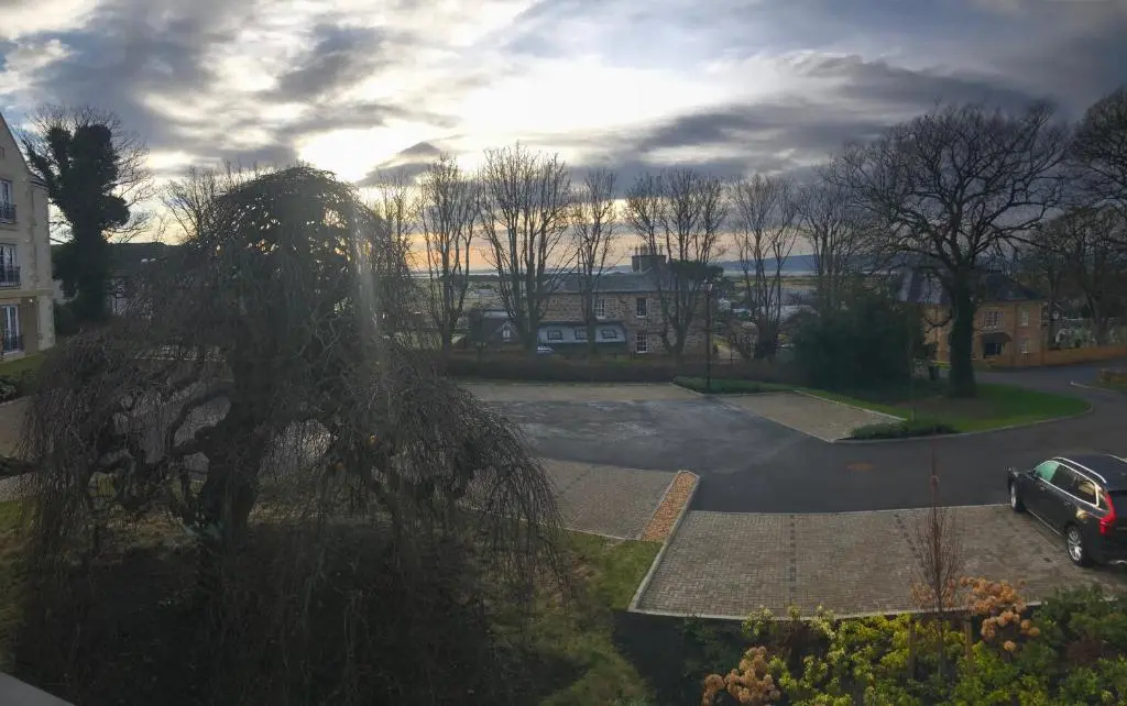 a view of a street with a car parked in a parking lot at Royal Golf Apartments in Dornoch