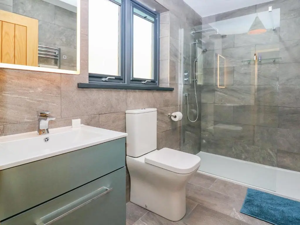 a bathroom with a toilet and a sink and a shower at Boat House in Invergarry