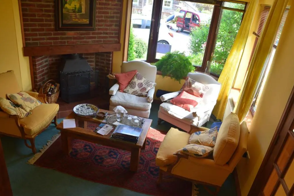 a living room with couches and a fireplace at Sunflower Bed & Breakfast in Findhorn