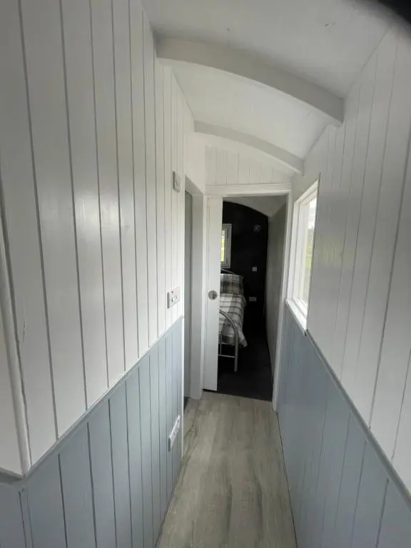 a hallway of a house with white walls at AC/DC Glamping in New Aberdour