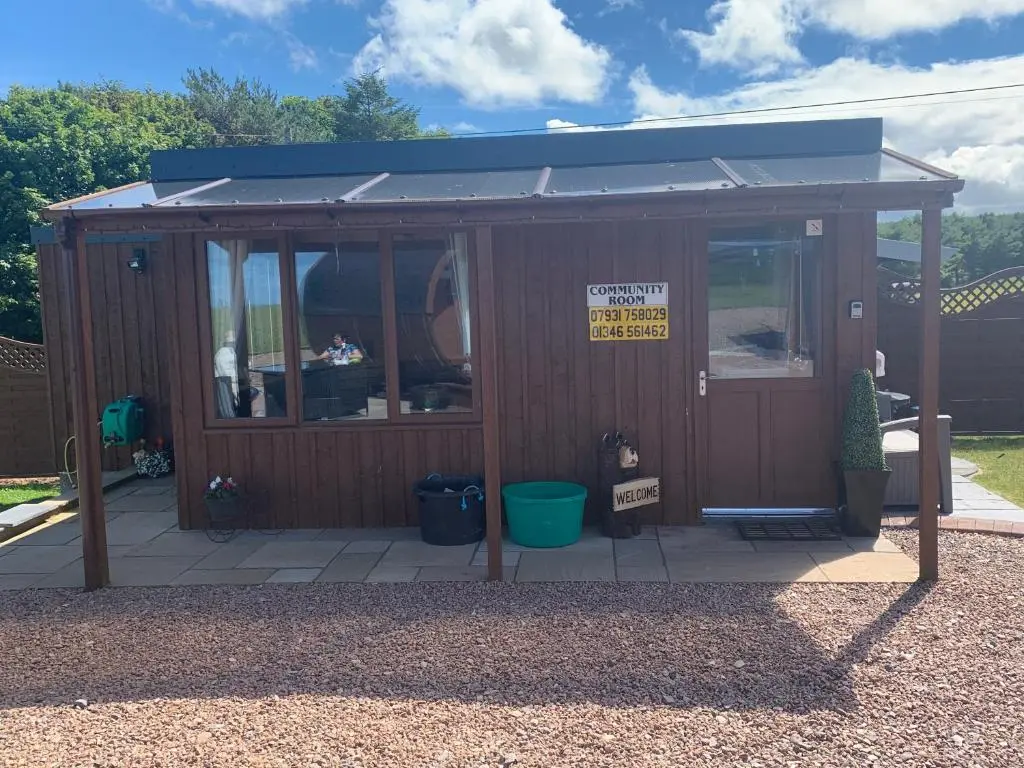 a small wooden building with a sign on it at AC/DC Glamping in New Aberdour