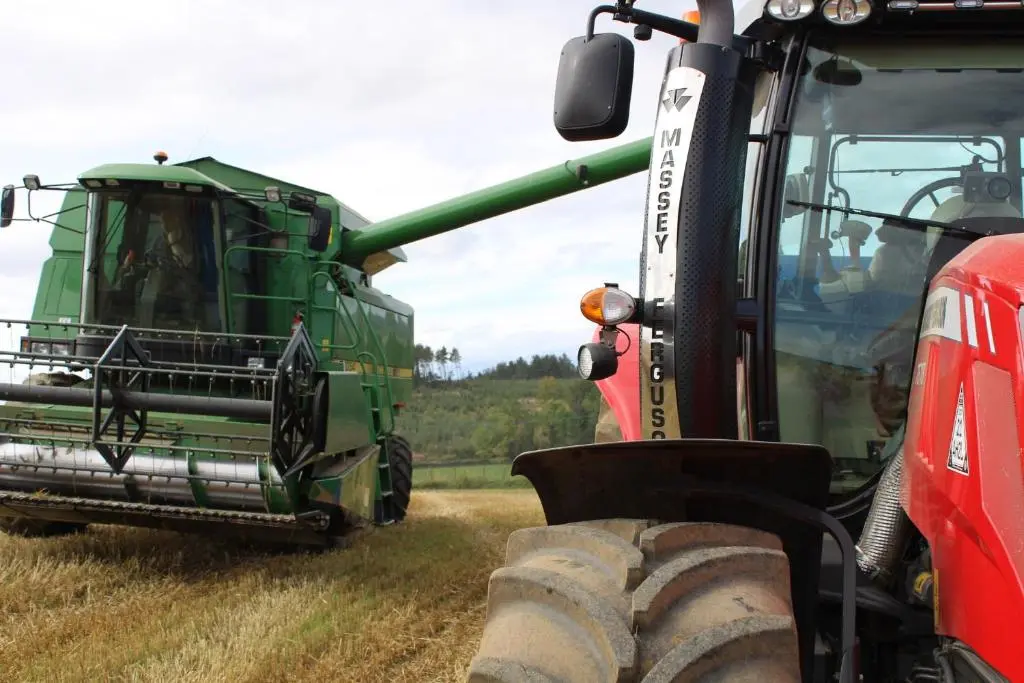 a green combine harvester in a field at Roualeyn in Huntly