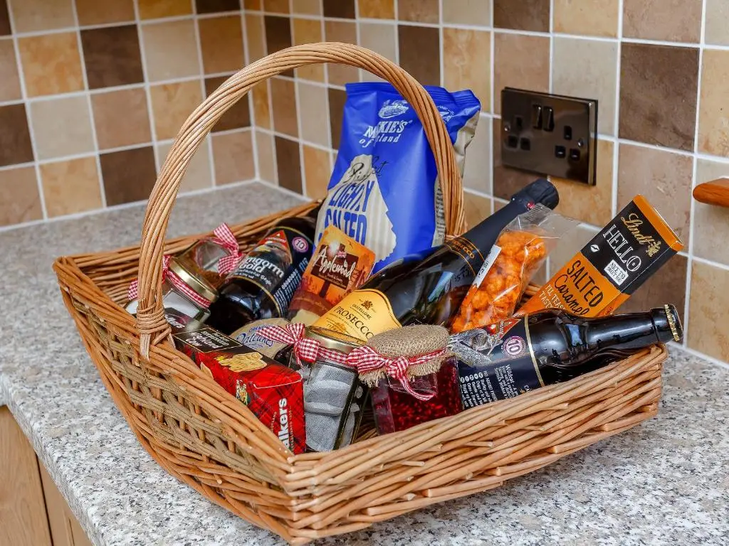 a basket filled with food and drinks on a counter at Sunnyside House in Duthil