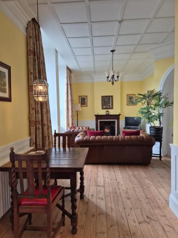 a living room with a couch and a table at The Old Convent Holiday Apartments in Fort Augustus