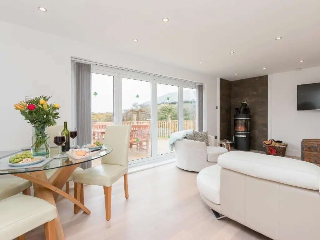 a living room with a white couch and a table at Inverspey in Kingston