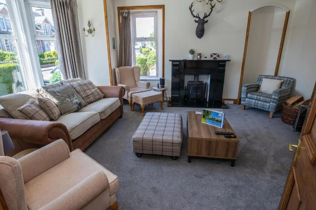 a living room with a couch and a coffee table at Aye Stay Home, city centre in Inverness