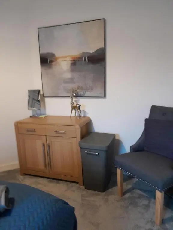 a living room with a couch and a chair at WELCOMEHOUSE close to east beach, shops, restaurants and RAF base in Lossiemouth