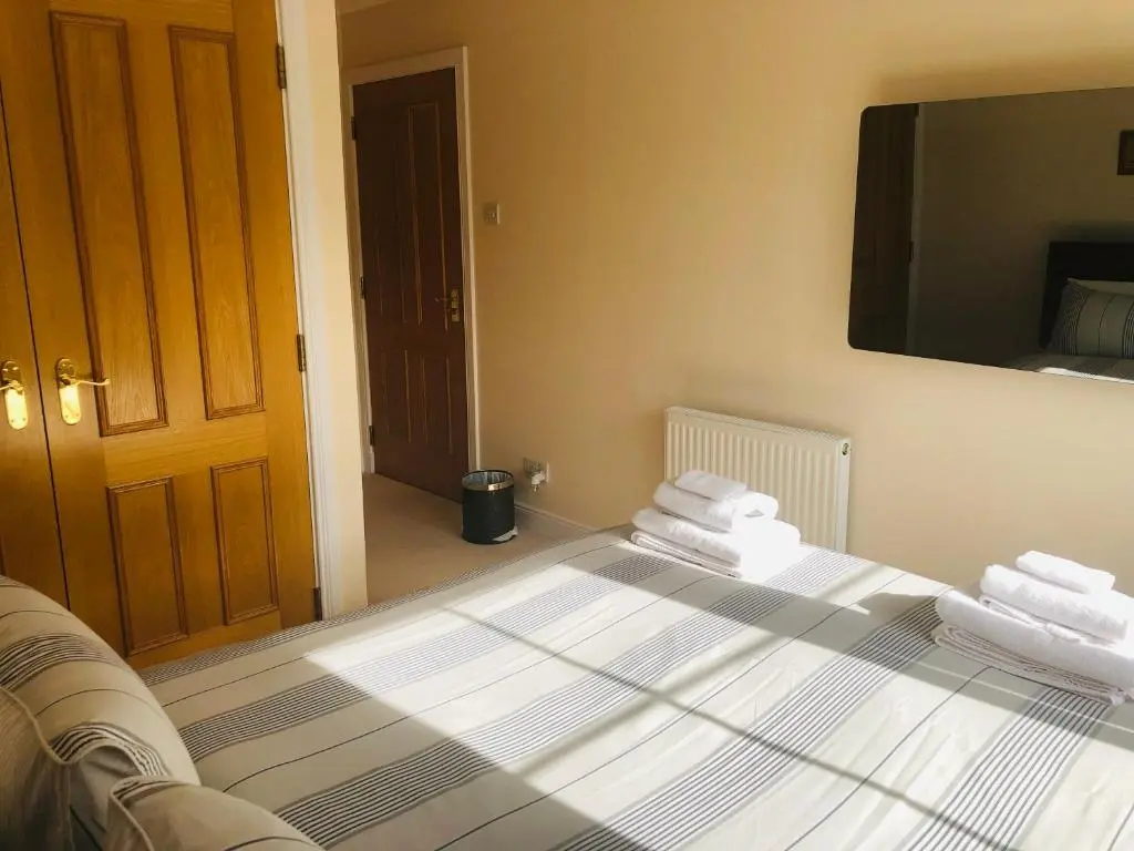a bedroom with a bed with folded towels on it at Taigh d'Luxe in Inverness