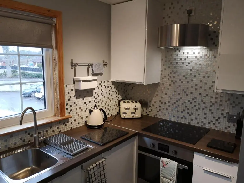 a kitchen with a sink and a counter top at Perfect Stay Apartments No.20 in Inverness