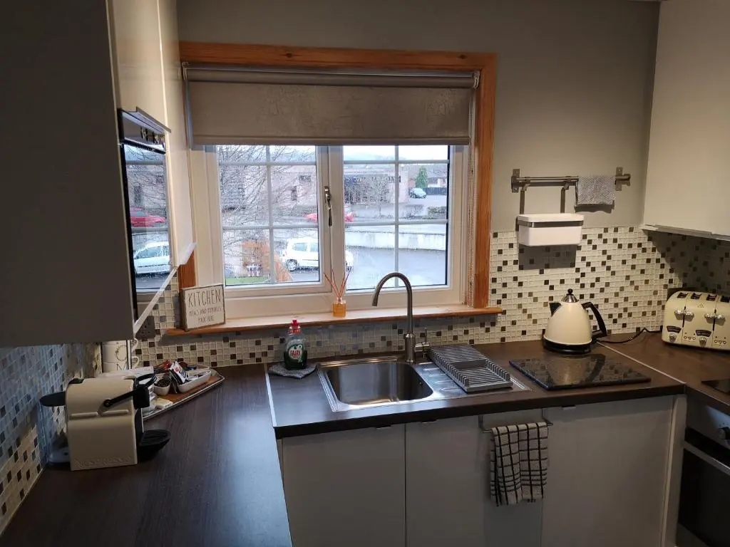 a kitchen with a sink and a window at Perfect Stay Apartments No.20 in Inverness