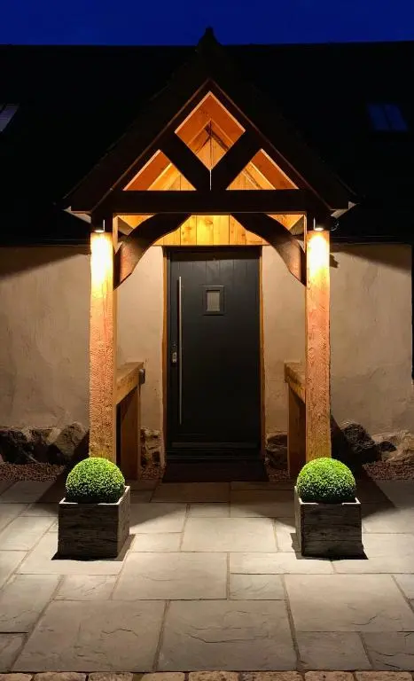 a front door of a house with lights at Balloan Cottage Cowshed in Inverness