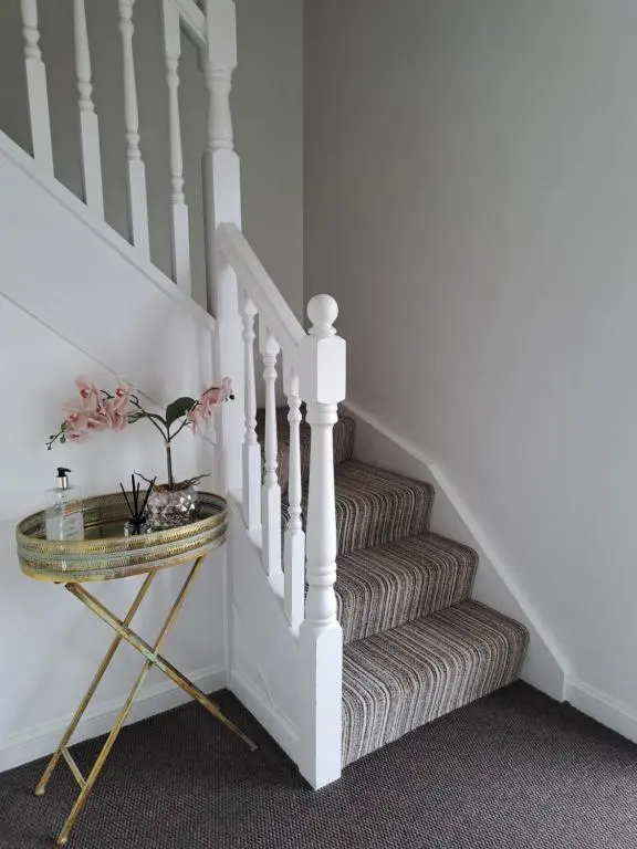 a stairway with a glass table and a white staircase at Inchmarlo Golf Resort, Banchory Villa 26 AS 00266F in Banchory