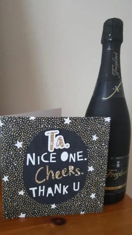 a bottle of wine and a sign next to a bottle of champagne at Inchmarlo Golf Resort, Banchory Villa 26 AS 00266F in Banchory
