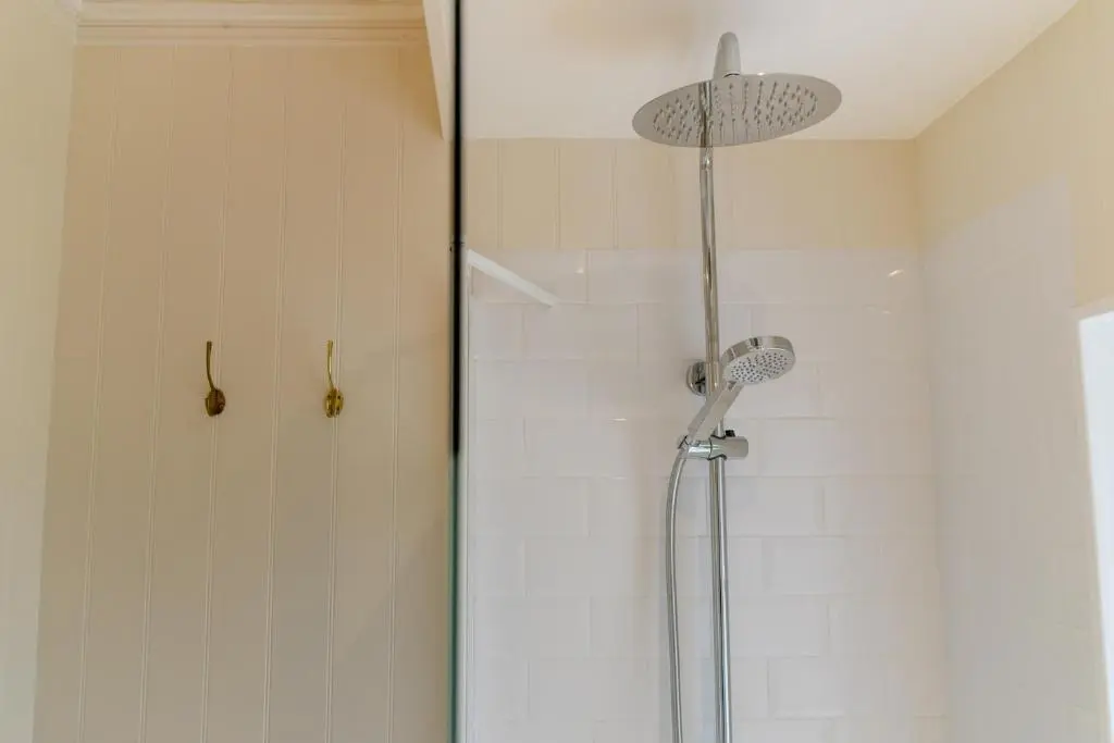a shower with a shower head in a bathroom at Scatwell House in Garve