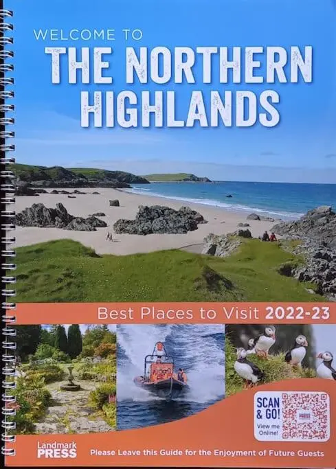 a book about the northern highlands with a picture of a boat on a beach at The Highland Studio Muir of Ord in Muir of Ord