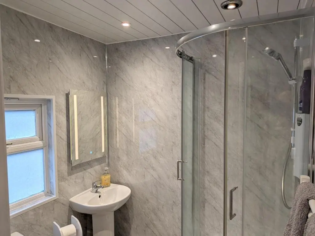 a bathroom with a shower and a sink at The Highland Studio Muir of Ord in Muir of Ord