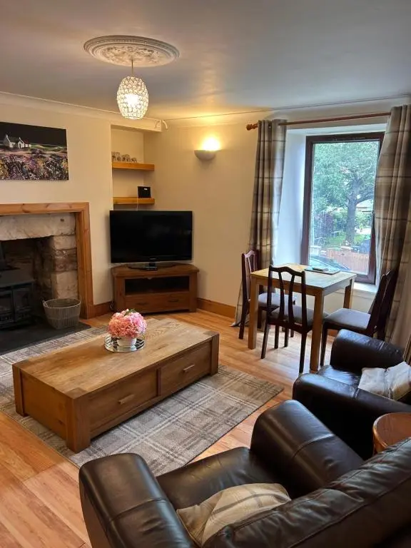 a living room with a couch and a coffee table at Telford Road Apartment in Inverness