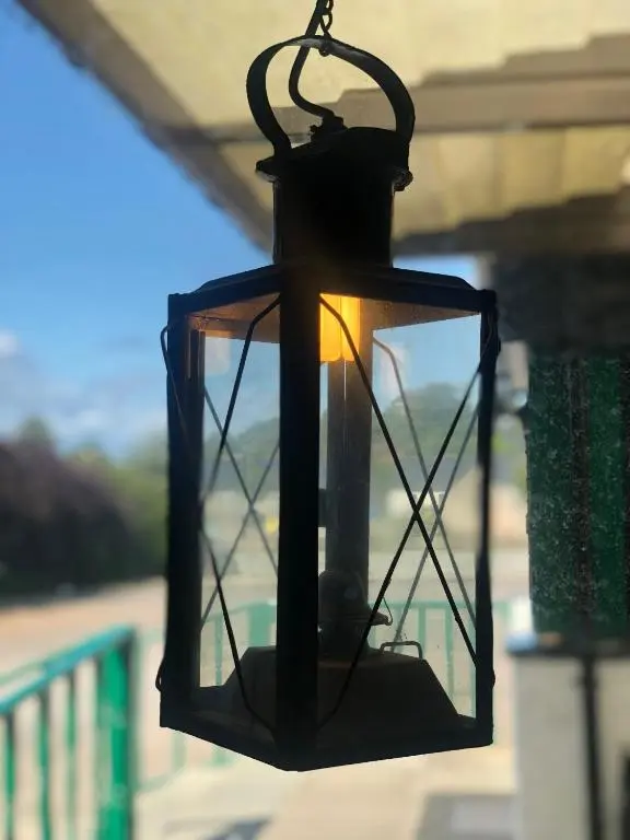 a black lantern hanging from a roof at The 1645 Inn in Nairn