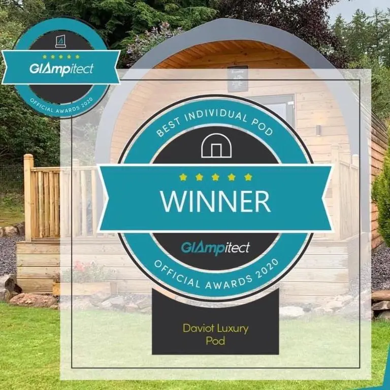 a sign in front of a garden with a fence at Daviot Luxury Pods in Inverness