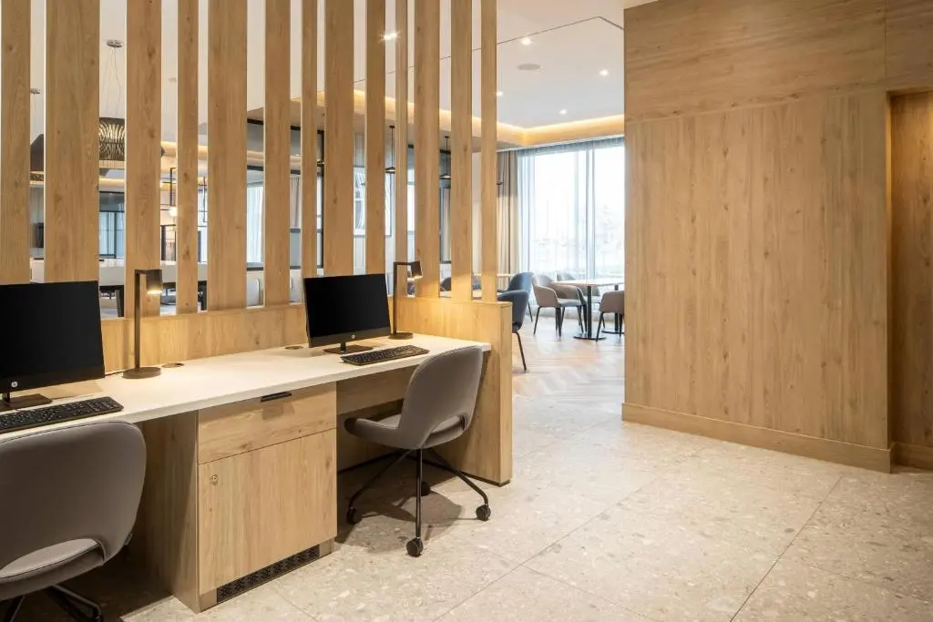 an office with two computers on a desk with chairs at Courtyard by Marriott Inverness Airport in Inverness