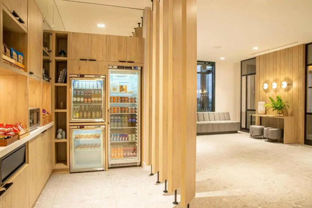 an open kitchen with a refrigerator in a room at Courtyard by Marriott Inverness Airport in Inverness