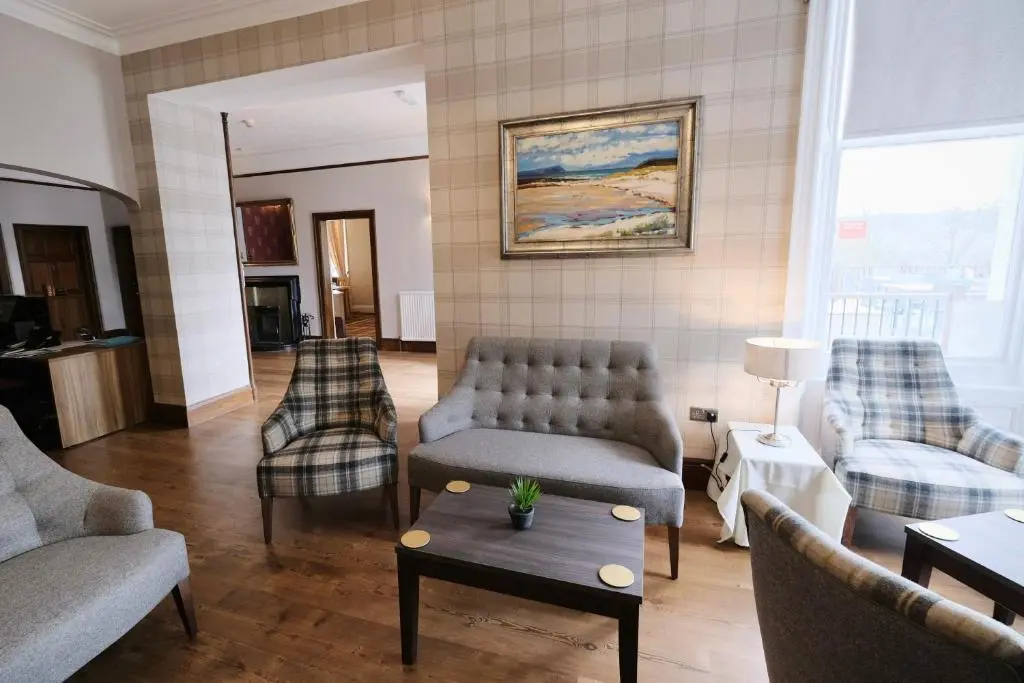 a living room with a couch and chairs and a table at Fife Lodge Hotel in Banff