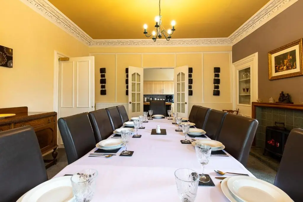 a conference room with a long table and chairs at Kinnaird Country House with Hot Tub in Pitlochry