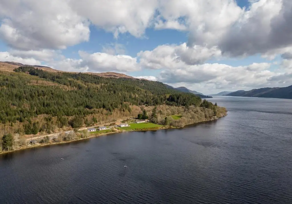 an island in the middle of a body of water at Shoreland Lodges - Cherry Lodge in Fort Augustus