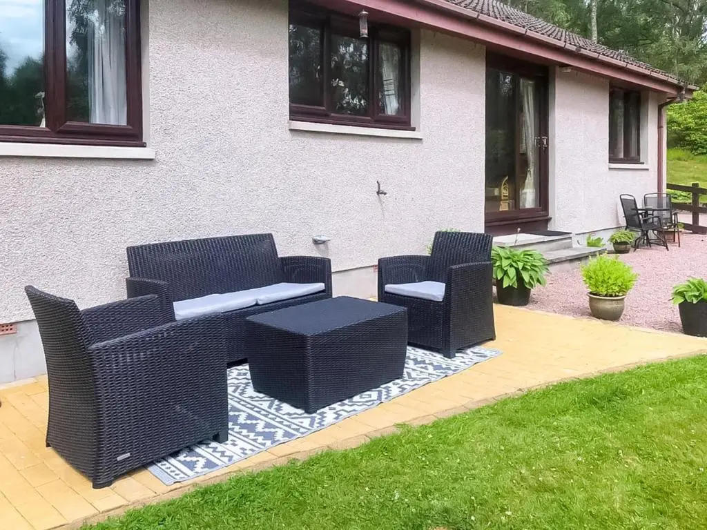 a group of chairs and a table on a patio at The Birches in Ardclach
