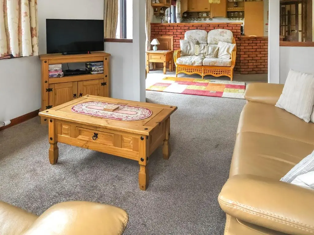 a living room with a couch and a coffee table at The Birches in Ardclach