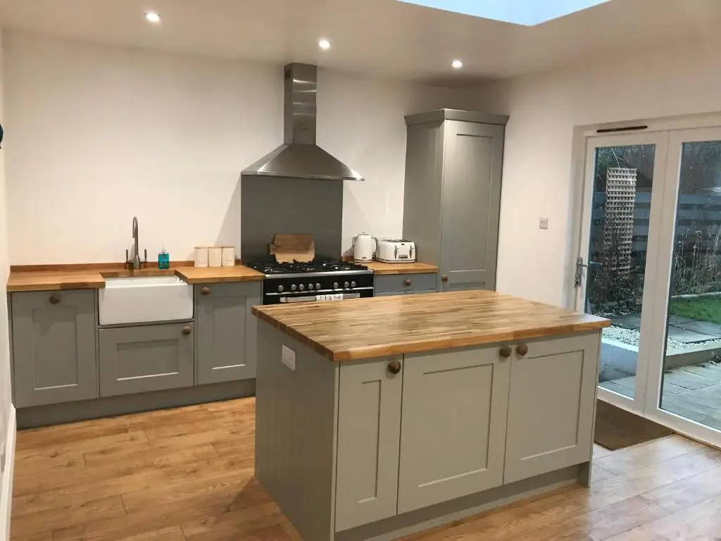a kitchen with gray cabinets and a stove top oven at Fantastic central location in Inverness