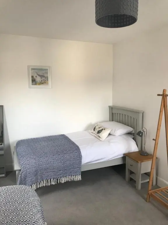 a bedroom with a white bed and a lamp at Fantastic central location in Inverness