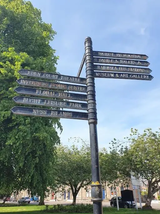 a pole with many street signs on it at Highland Historical Home in Inverness City Centre in Inverness
